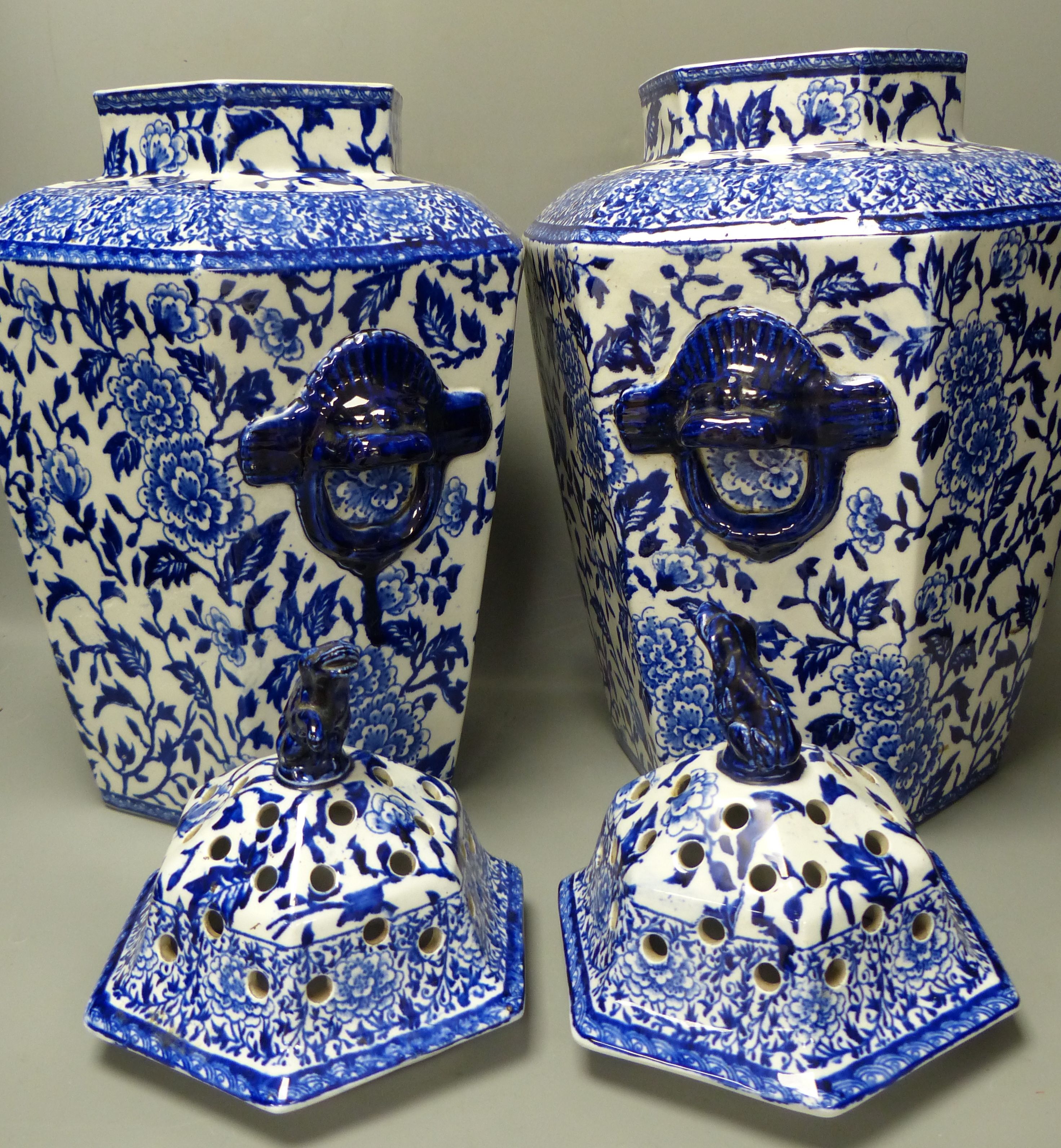 A pair of large early 20th century blue printed pottery pot pourri vases and covers, height 36cm